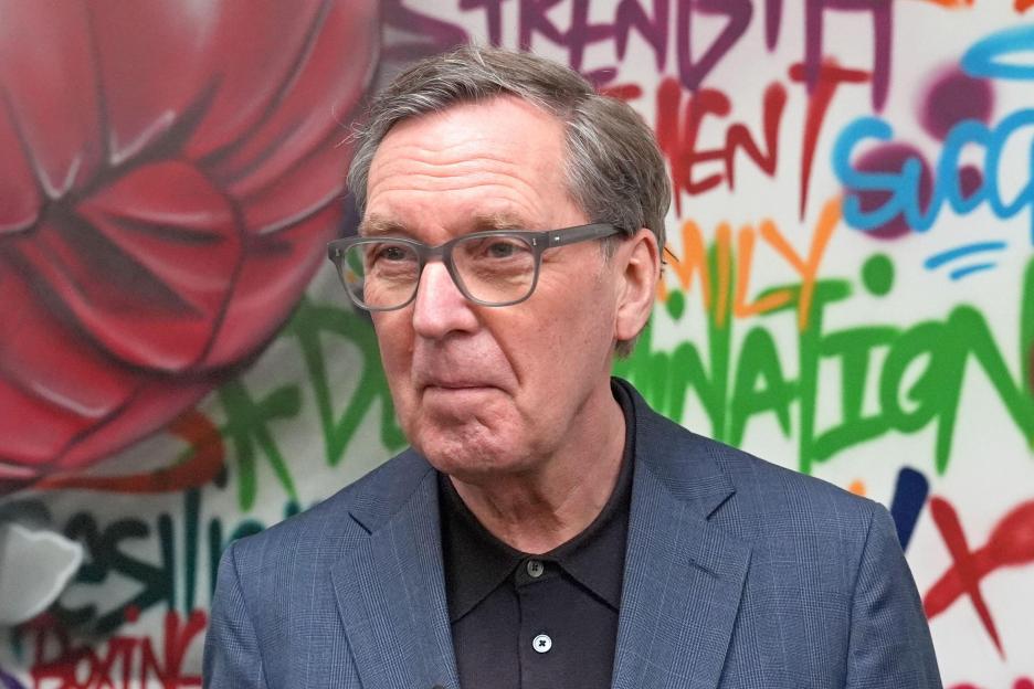 Former health secretary Alan Milburn standing in front of a graffiti mural at Boxing Futures.