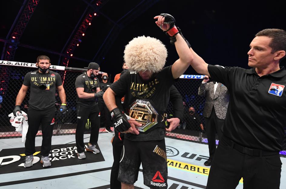 Khabib Nurmagomedov celebrates his victory with the lightweight title belt after UFC 254.
