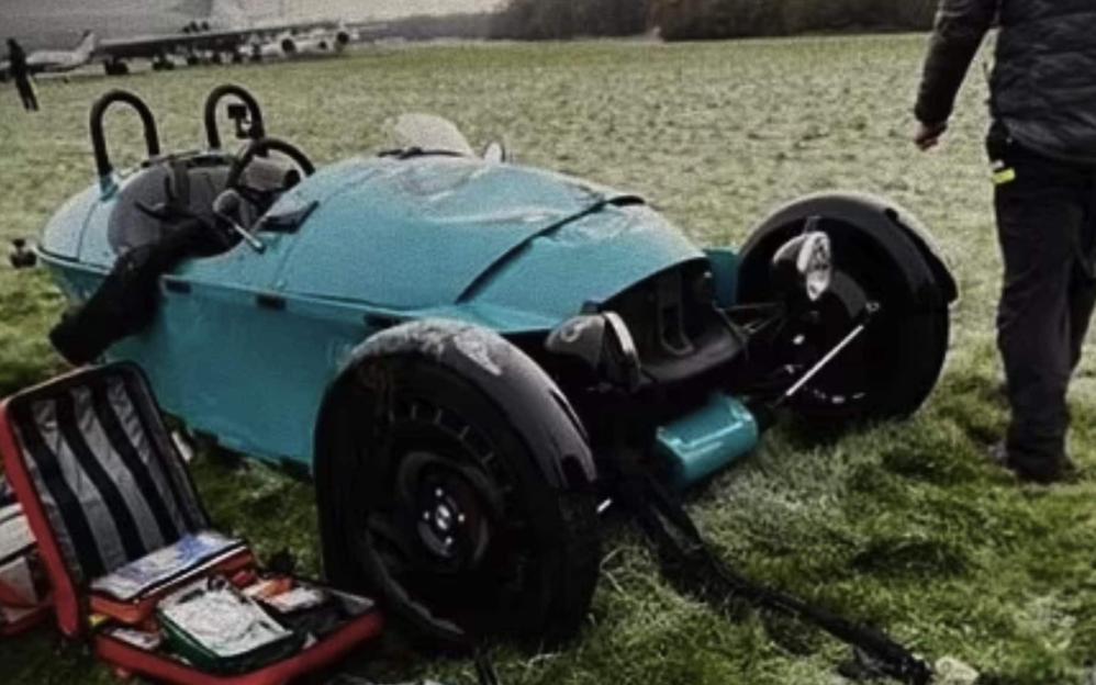 Damaged turquoise car after Andrew 'Freddie' Flintoff's 2022 crash, with a first aid kit nearby.