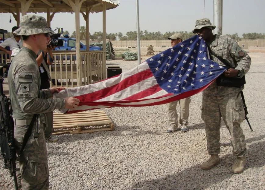 epa13267926 (FILE) - US soldiers fold their national flag while preparing to leave Scania military base in Hila south of Baghdad, Germany, 15 July 2010 (reissued on 28 September 2026). The internat...
