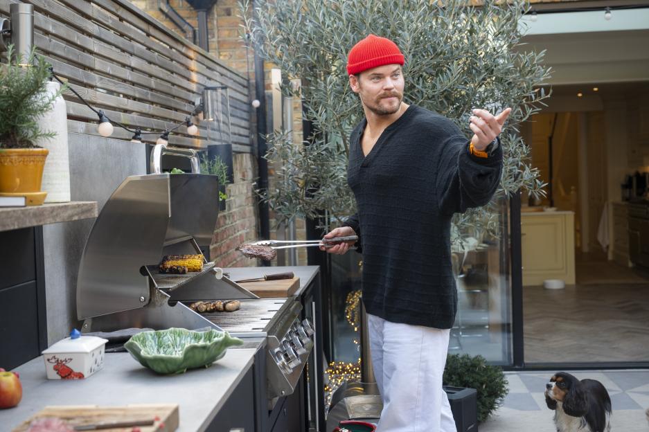 Ryan Libbey grilling outdoors.
