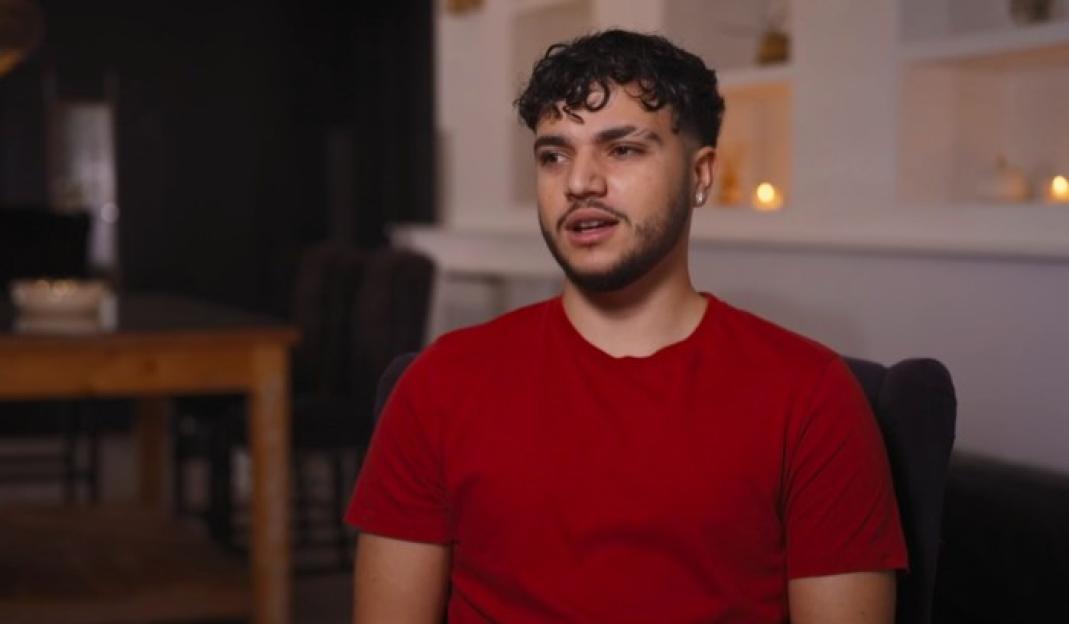 Junior Andre sitting and looking to the left of the frame.