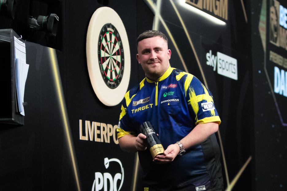 Liverpool, UK. 23rd Apr, 2026. Luke Littler of England poses with his trophy after winning his Final match against Jonny Clayton of Wales during the 2026 BetMGM Premier League Darts, Night 12 at M & S Bank Arena, Liverpool, England on 23 April 2026 C