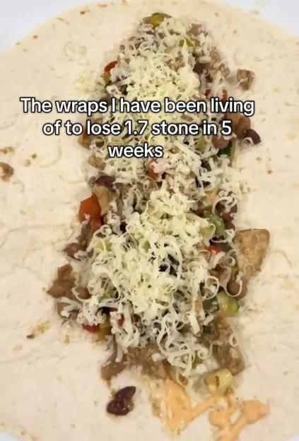 Tortilla wrap filled with shredded cheese, beans, vegetables, and a creamy sauce.