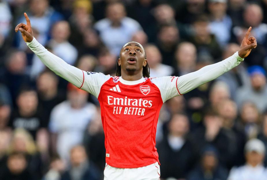 Eberechi Eze celebrates his goal for Tottenham Hotspur with arms raised and fingers pointing upwards.