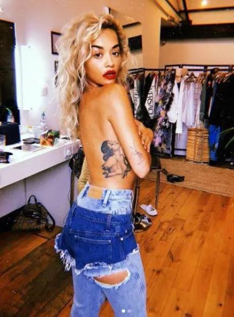 Rita Ora showing her tattoo.