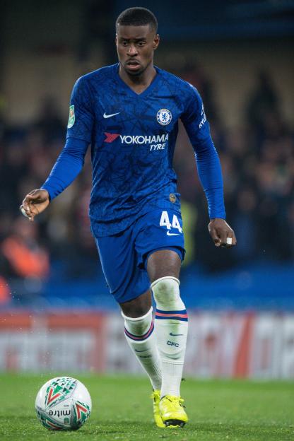 Marc Guehi of Chelsea FC controls a soccer ball.