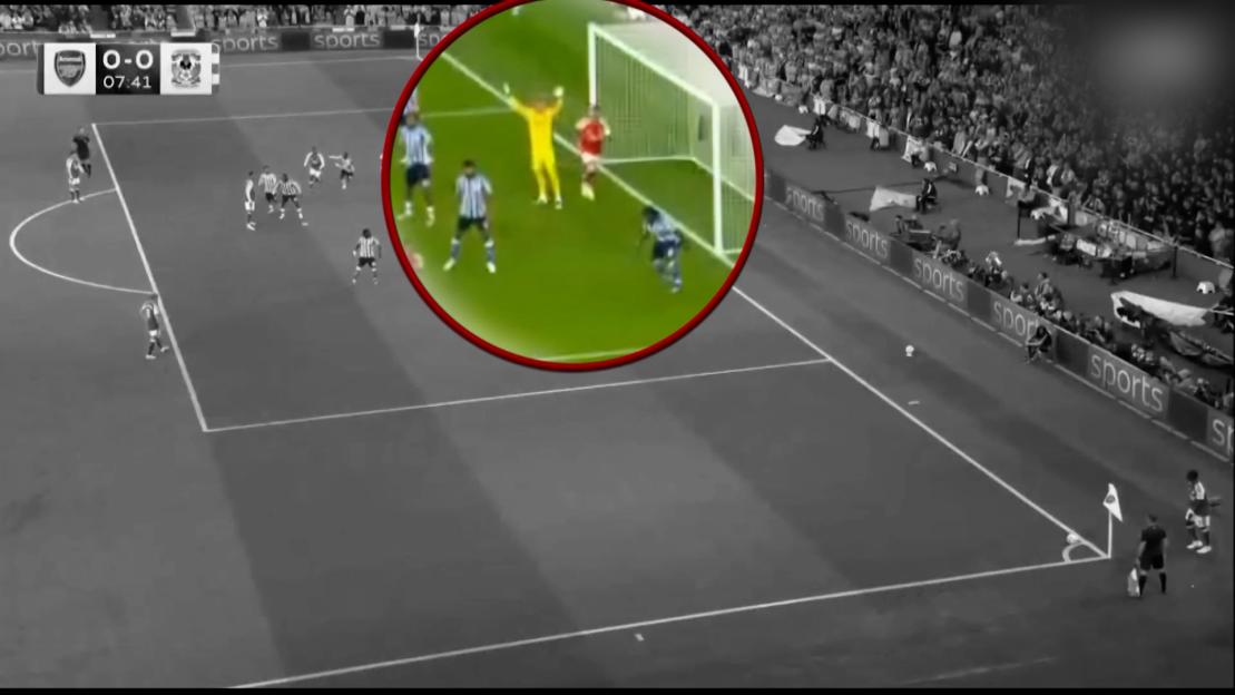 Still from a soccer game showing a zoomed-in view of players near the goal, superimposed on a wider, grayscale view of the field.