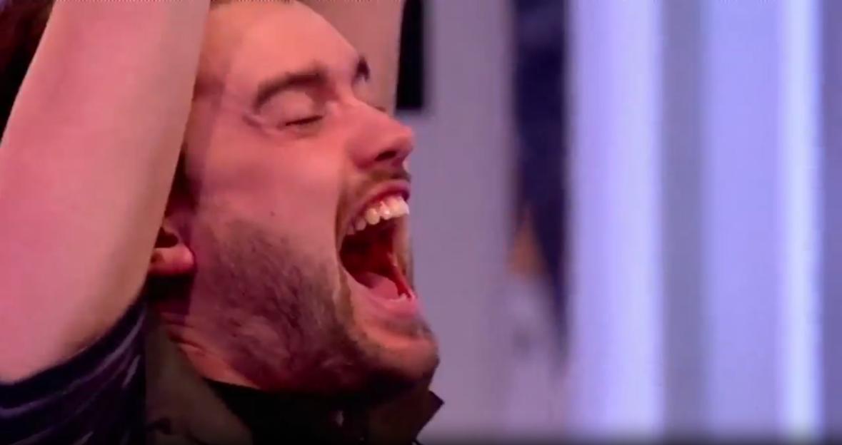 Man with beard screaming with his mouth wide open.