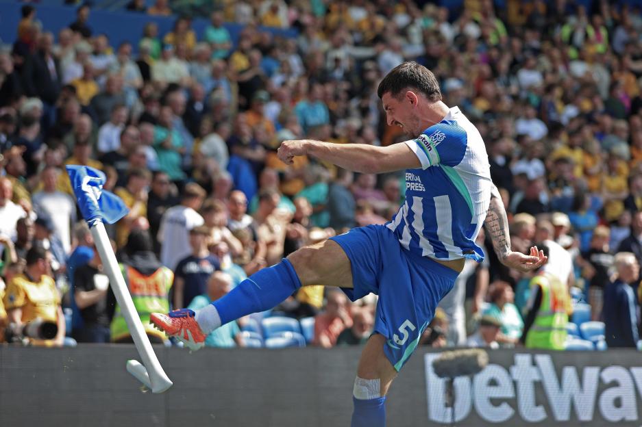 BRIGHTON, ENGLAND, MAY 09: GOAL 2-0, Lewis Dunk of Brighton & Hove Albion goal celebration kicking he corner flag after scoring a goal to put Brighton & Hove Albion 2-0 ahead during the Premier League match between Brighton & Hove Albion v Wolverhamp