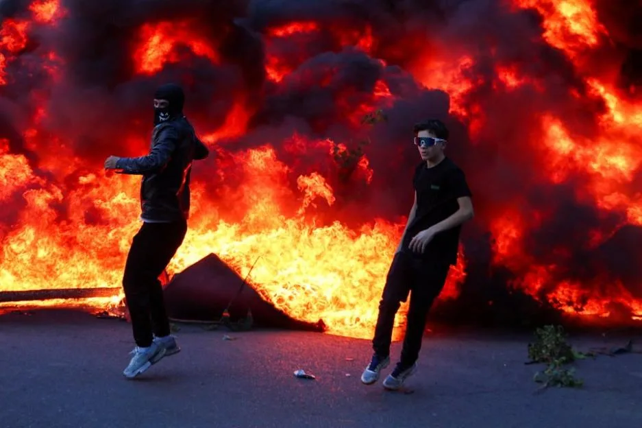 Buildings burn & huge blazes in middle of street as rioters clash with cops during anti-government protests in Albania