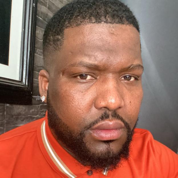 Headshot of Gelson Fernandes, also known as Matchas, wearing an orange polo shirt.