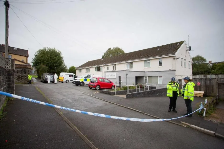 A 61-year-old man has been arrested on suspicion of murder after a woman who crashed her car died in Bridgend, Wales, UK