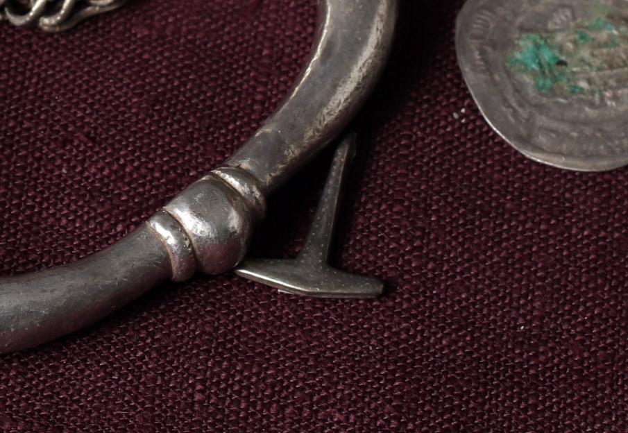Viking silver Thor's Hammer with bracelet and coin fragments.