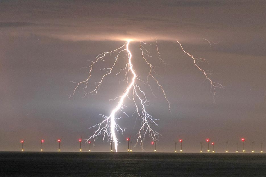 Lightning striking over the Rampion Offshore Wind Farm.