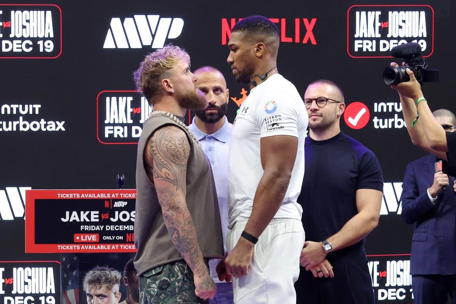 Jake Paul and Anthony Joshua face off at a press conference.