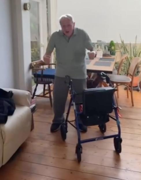 Terence Donovan dances with a walker.