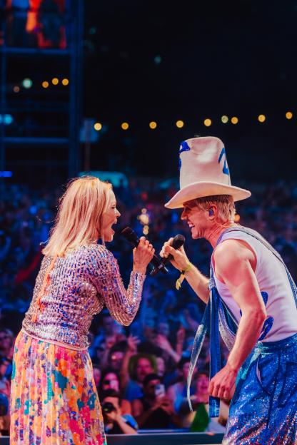 Belinda Carlisle and Jake Shears performing on stage.