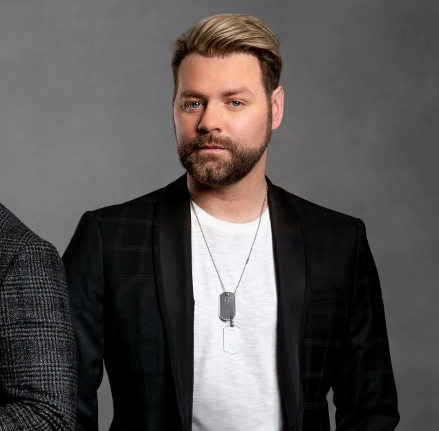 Album cover for Boyzlife's "Strings Attached" featuring Shane Lynch and Brian McFadden, with the Royal Philharmonic Orchestra.