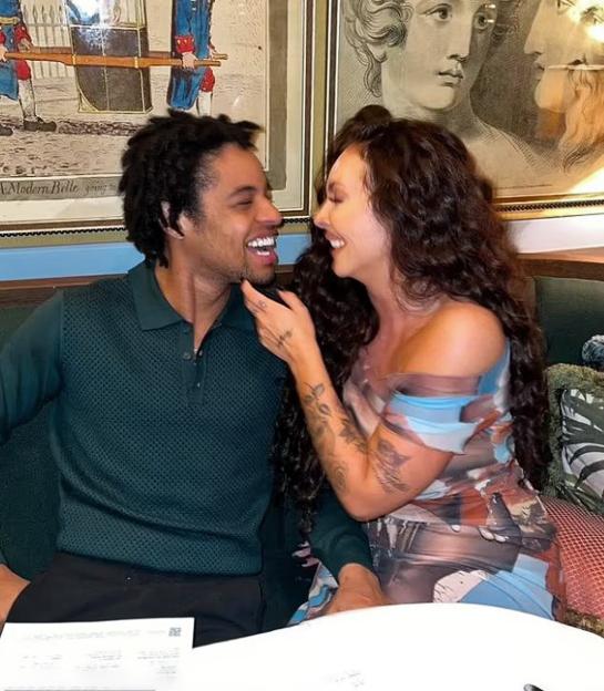 Jesy Nelson and Zion Foster smiling at each other.