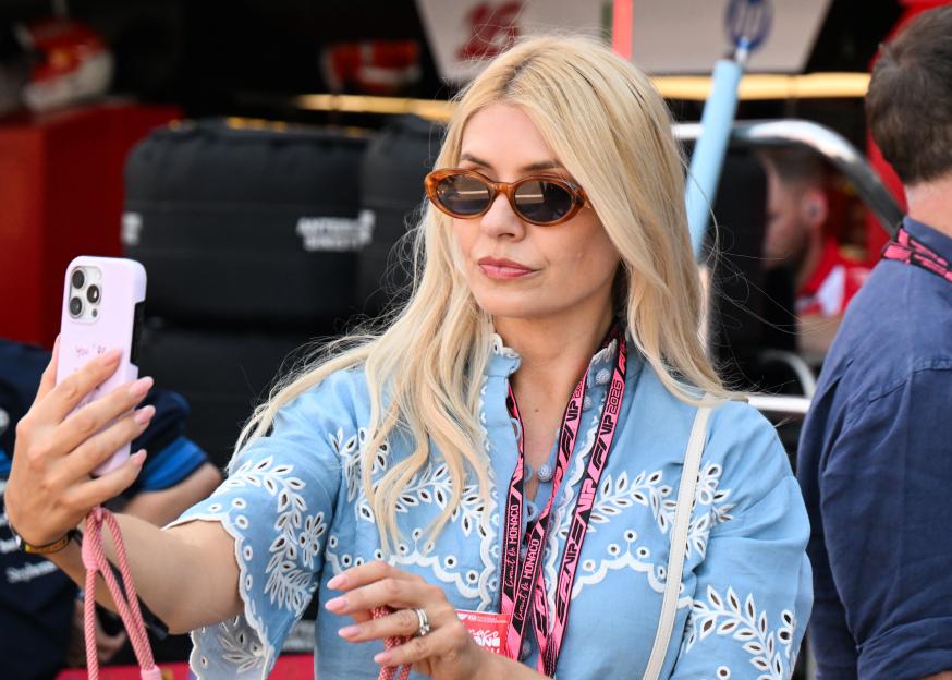Holly Willoughby takes a photo in the pit lane during qualifying ahead of the F1 Grand Prix of Monaco.