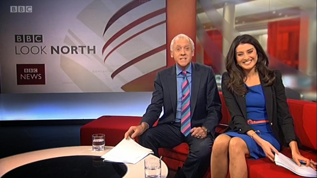 Harry Gration and Amy Garcia of BBC Look North sitting on a red sofa on a news set.