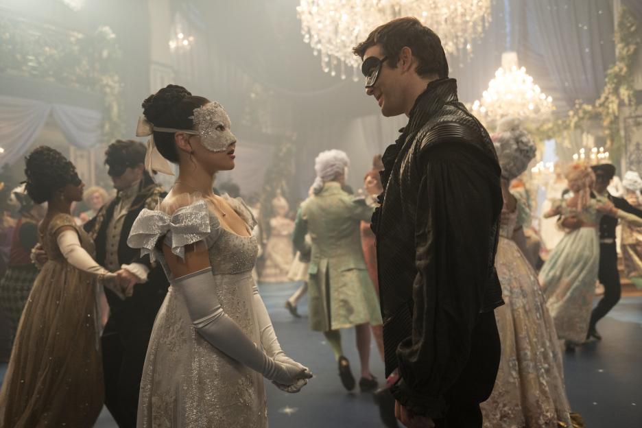 Benedict and Sophie look at each other at a masked ball.