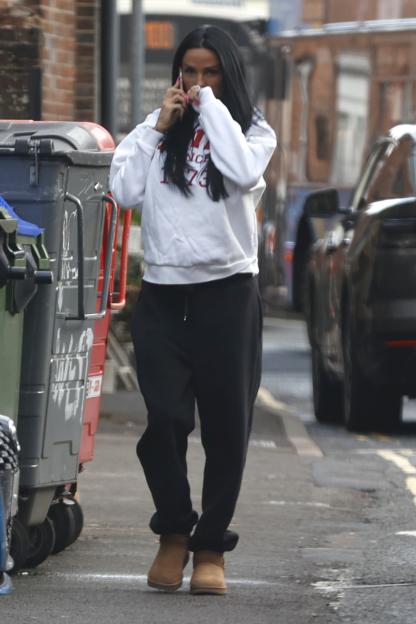 Katie Price talking on the phone outside her home.