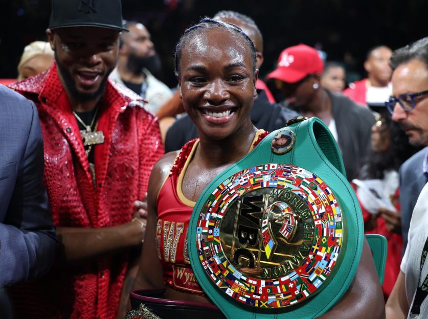 Claressa Shields smiling with her championship belt after defeating Kaye Scott.