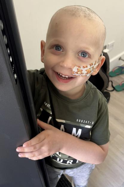 Raffi Starkowitz smiling with a bandage on his cheek and nose.