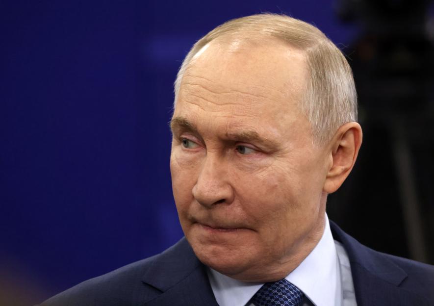 Russian President Vladimir Putin in a dark suit and patterned tie.