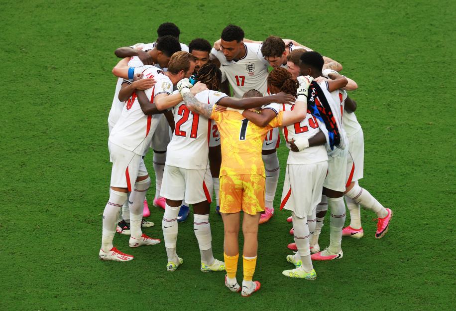 England football players huddle together on the field during a quarter-final match.