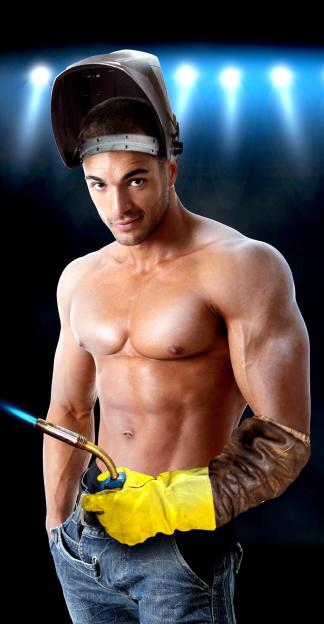 Muscular man with a welding mask on his head and a welding torch in his gloved hand.
