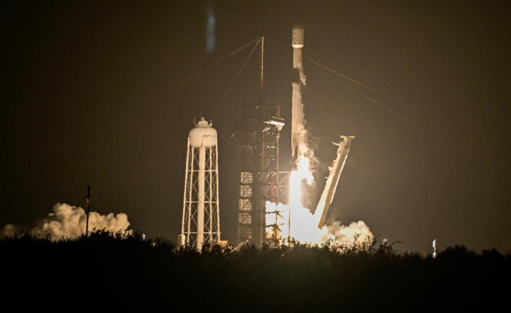 : A SpaceX Falcon 9 rocket lifts off carrying two moon landers from the Kennedy Space Center