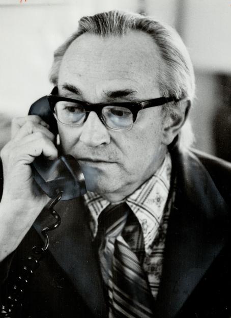 Dr. Alex Comfort talking on the phone.