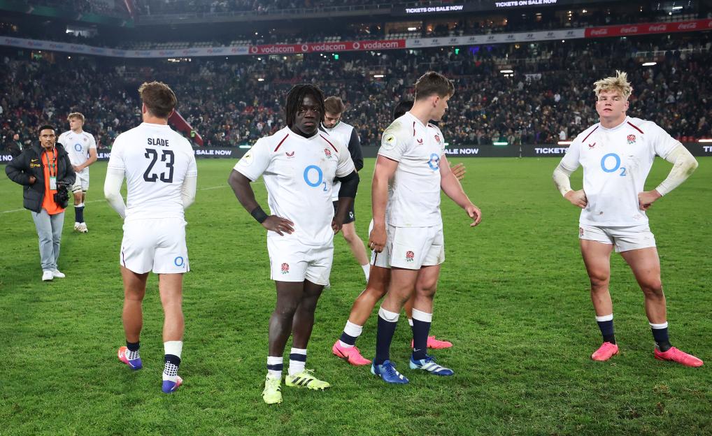 Asher Opoku-Fordjour and Henry Pollock appear dejected on the field after a rugby match.