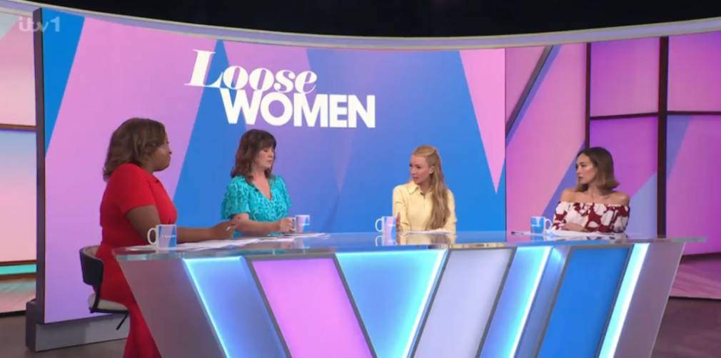 Four women, including Brenda Edwards and Stacey Solomon, sit at a table on the Loose Women set, with the show's logo behind them.