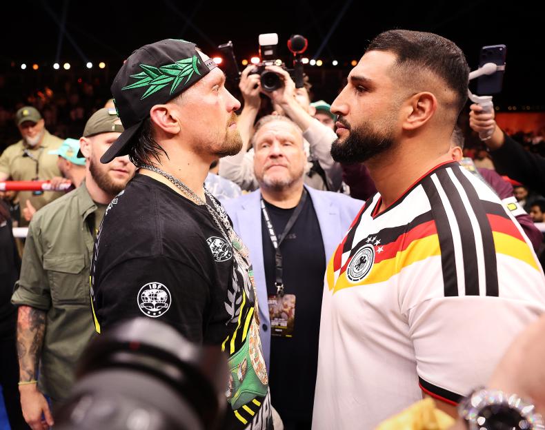 Two boxers face each other intensely at the "Glory in Giza Fight Night" event.