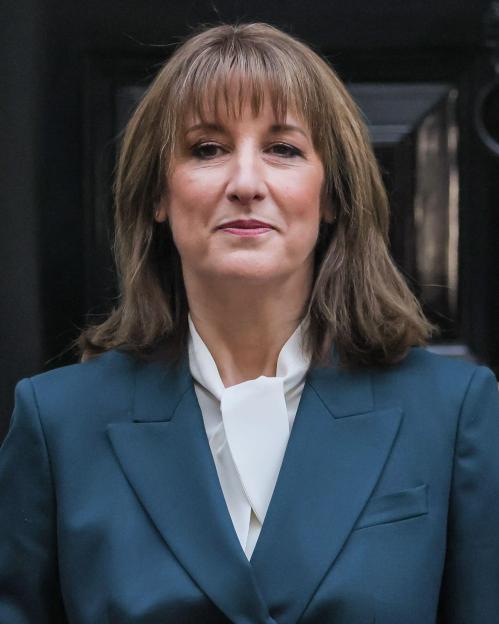 London, UK. 26th Nov, 2025. Rachel Reeves, Chancellor of the Exchequer of the United Kingdom, presents the red 'budget box', her ministerial despatch box, to waiting press outside 11 Downing Street. Her Treasury team step out with her. She then departs.