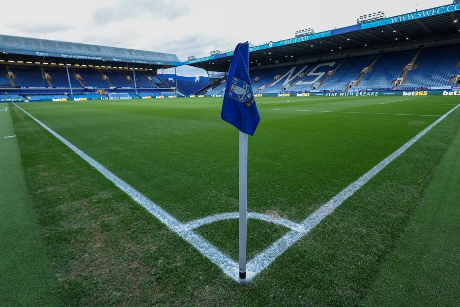 A close-up shot of a corner flag and the corner of a football pitch.
