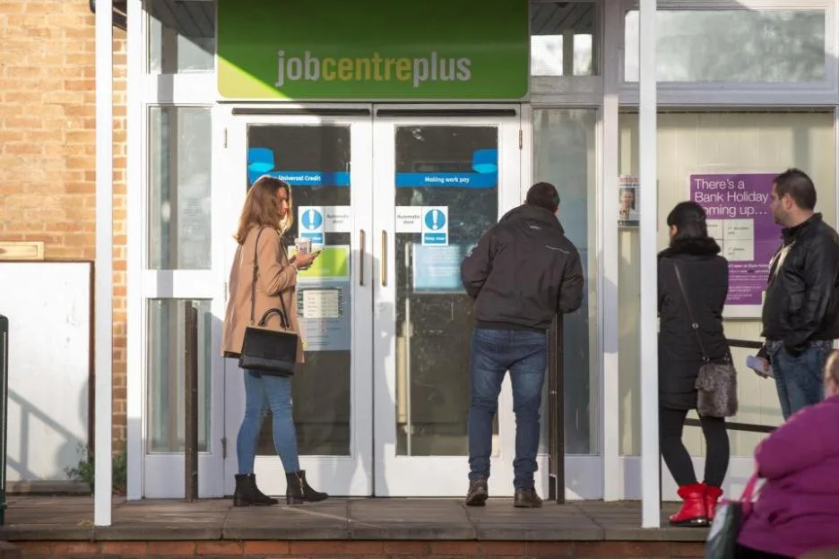 People queuing to go into the job centre in Cambridge .