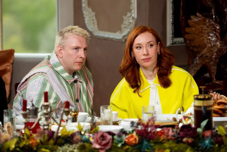 Joe Lycett and Professor Hannah Fry sitting at a table with food and drinks.