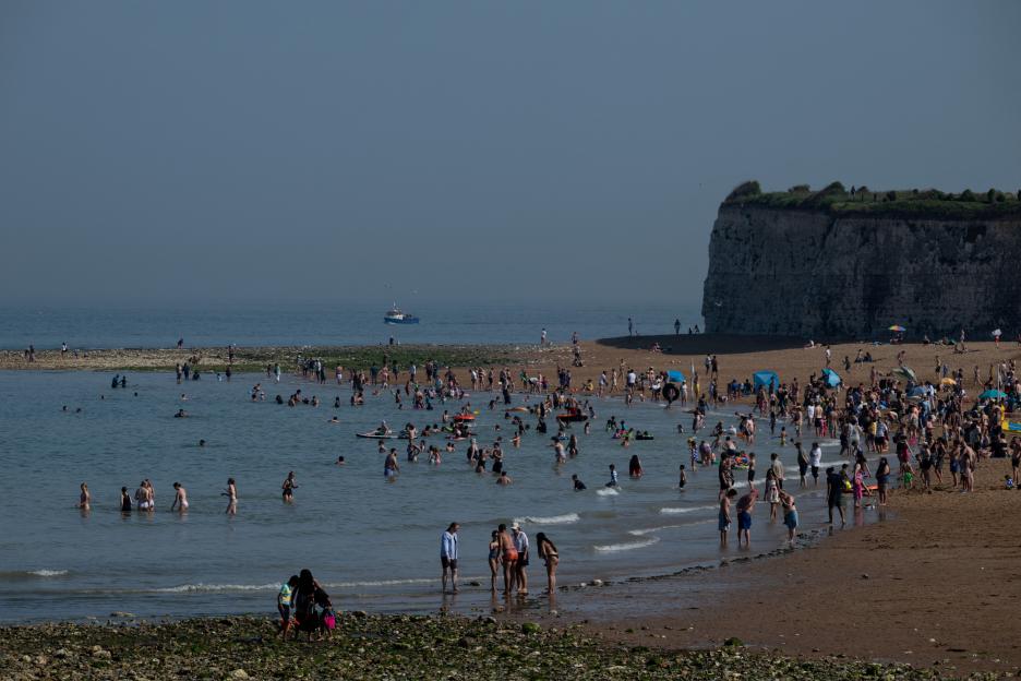 People gather at Joss Bay beach in Broadstairs, Britain, as temperatures rise.
