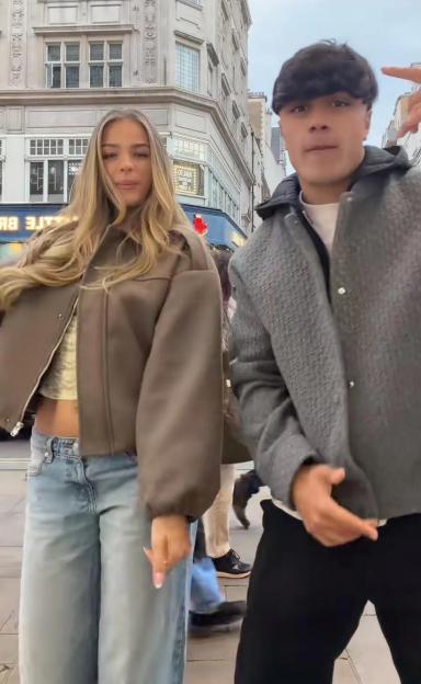 Danny Bretherton and Tallulah Metcalfe in a city street.