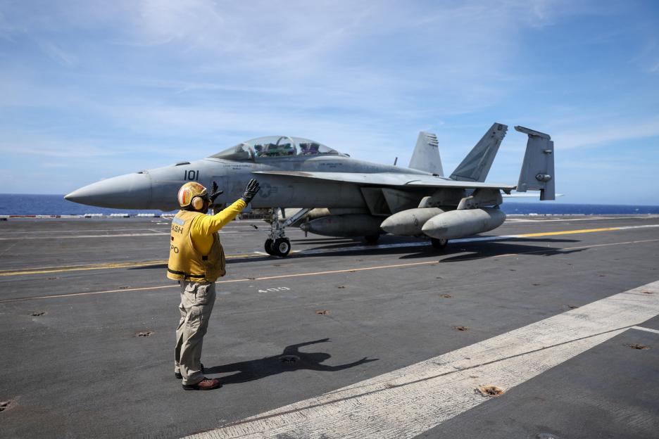 An F-18 jet fighter prepares to take off from the USS Theodore Roosevelt as the aircraft carrier participates in RIMPAC military exercises.
