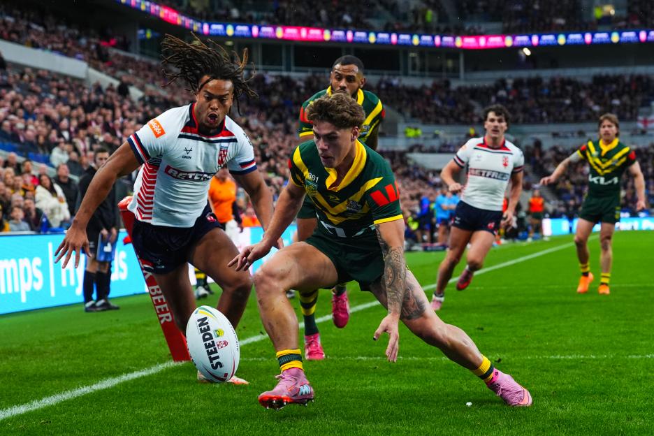 England's Young and an Australia player chase a rugby ball.