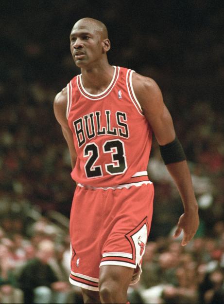 Michael Jordan in a red Chicago Bulls uniform on the court.