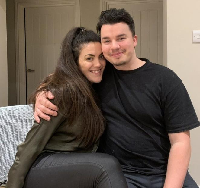 Woman and man posing for a photo.