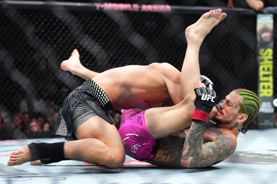 Sean O'Malley wrestling Song Yadong in a bantamweight bout during UFC 324.