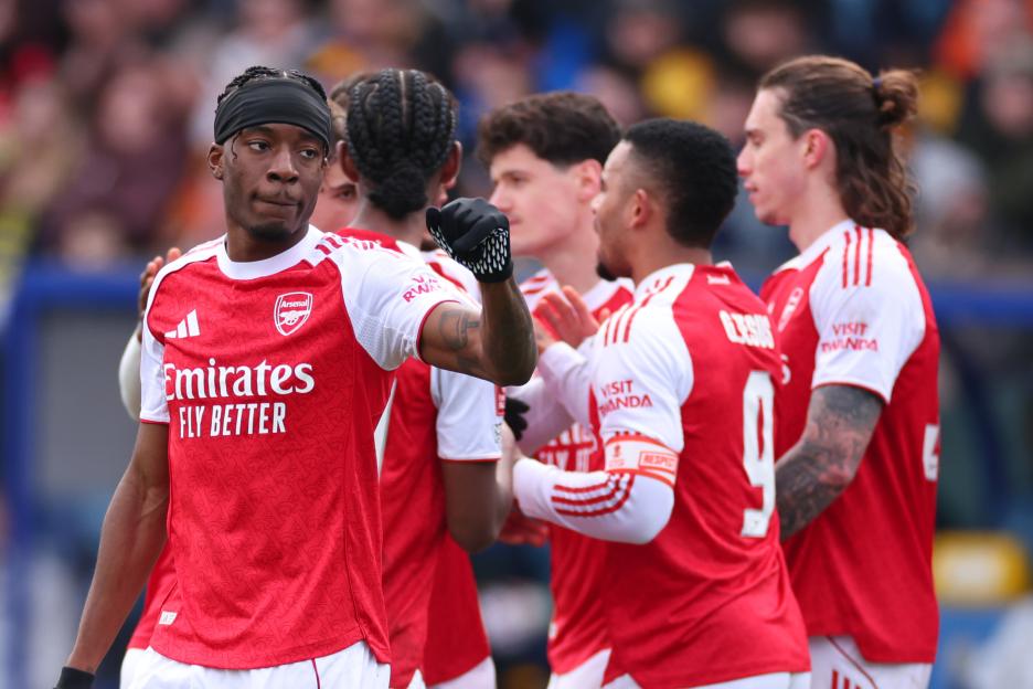 Noni Madueke of Arsenal celebrates scoring with teammates.